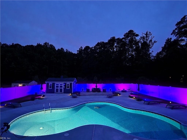 view of swimming pool with a patio and an outdoor structure