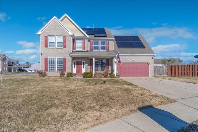 view of front of property with covered porch, solar panels, a garage, and a front lawn