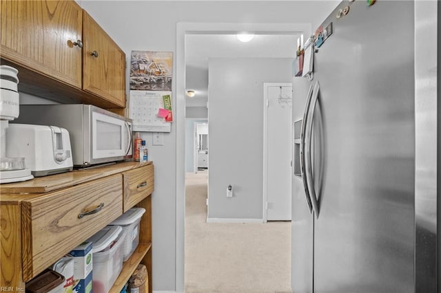 kitchen with light colored carpet and stainless steel refrigerator with ice dispenser