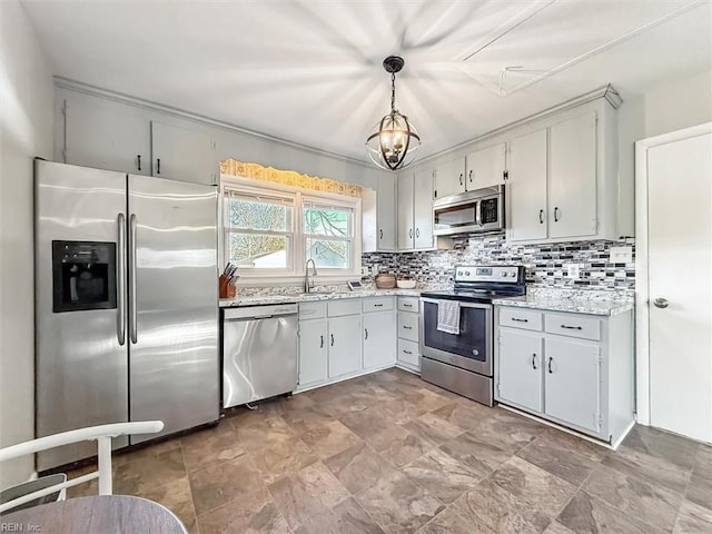 kitchen with pendant lighting, stainless steel appliances, a notable chandelier, backsplash, and sink