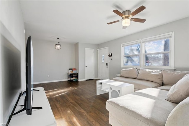 living room featuring ceiling fan and dark hardwood / wood-style floors