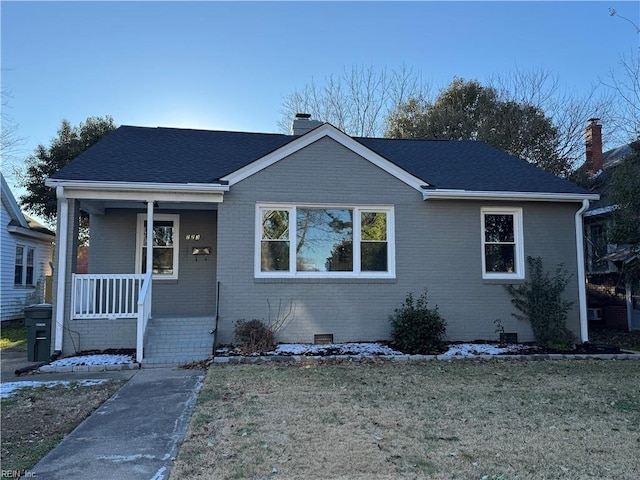 view of front of home with a porch and a front lawn