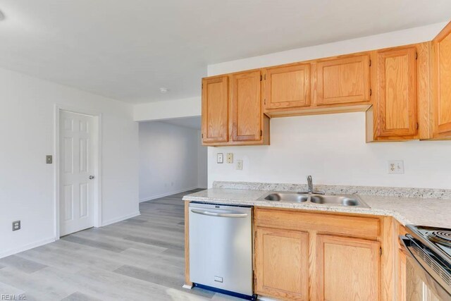 kitchen with sink, stainless steel appliances, light wood-type flooring, and light brown cabinetry