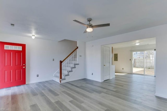 foyer featuring electric panel, light wood-type flooring, and ceiling fan