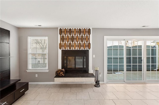 living room featuring a wealth of natural light and light tile patterned flooring