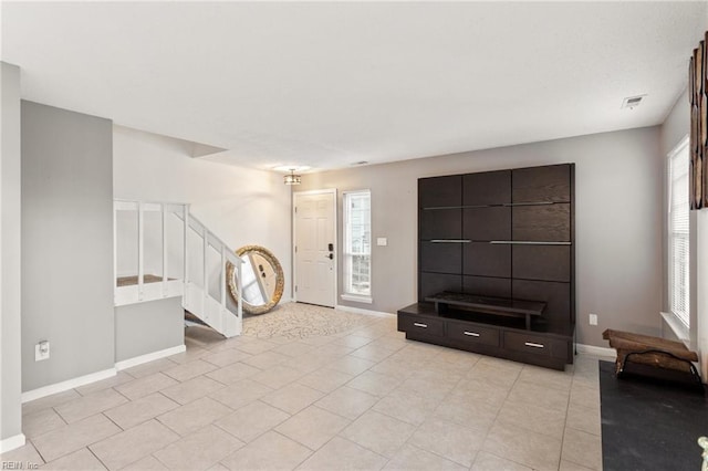 foyer entrance featuring a healthy amount of sunlight and light tile patterned floors