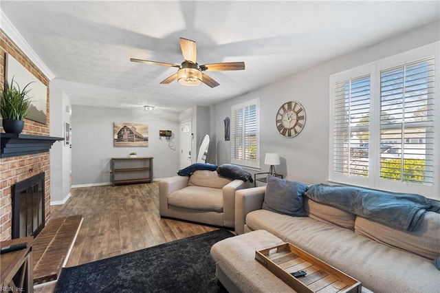 living room featuring a fireplace, hardwood / wood-style floors, and ceiling fan