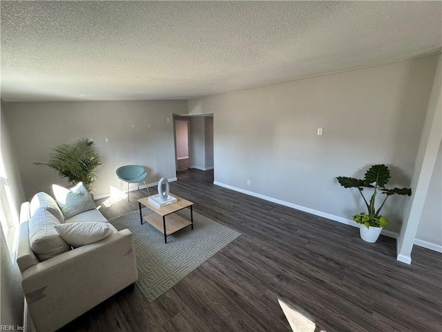 living room featuring dark hardwood / wood-style floors and a textured ceiling