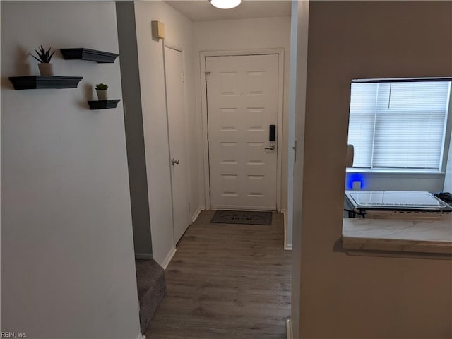 corridor with light hardwood / wood-style flooring