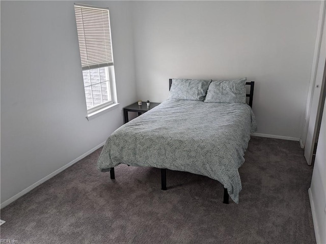 bedroom featuring dark colored carpet