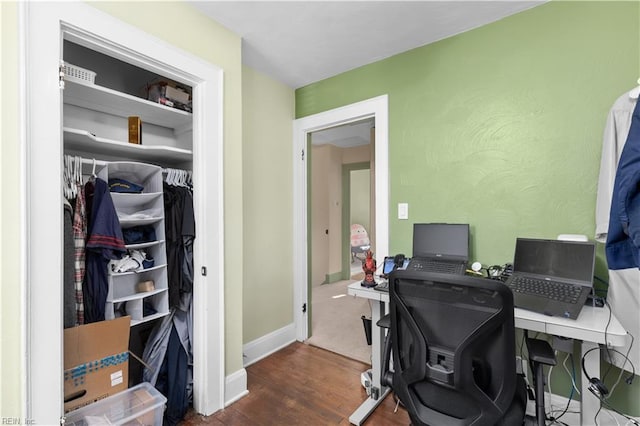 home office with dark hardwood / wood-style floors