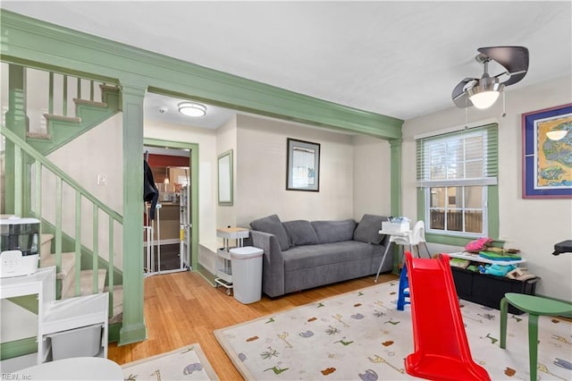 living room featuring ceiling fan and wood-type flooring