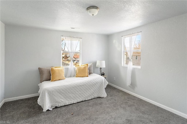 carpeted bedroom featuring multiple windows