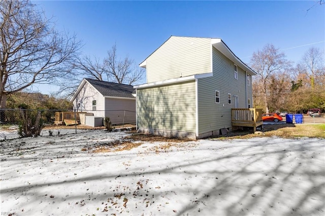 view of snow covered rear of property