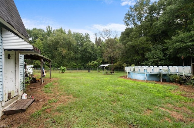 view of yard with a fenced in pool