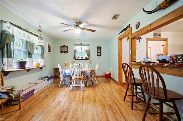 dining area featuring ceiling fan, a healthy amount of sunlight, and light wood-type flooring