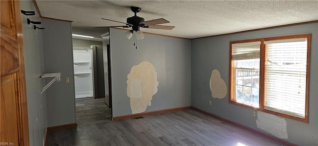 unfurnished bedroom with multiple windows, ceiling fan, a closet, and dark wood-type flooring