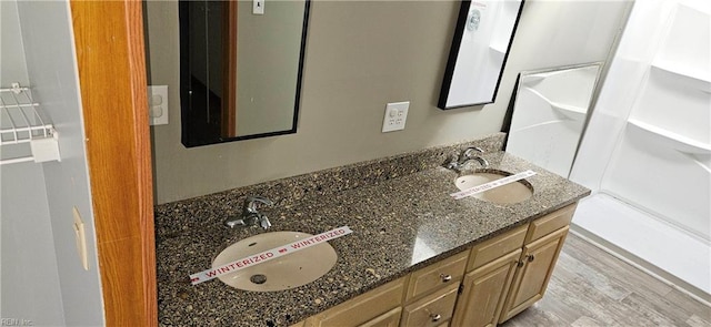 bathroom with hardwood / wood-style floors and vanity