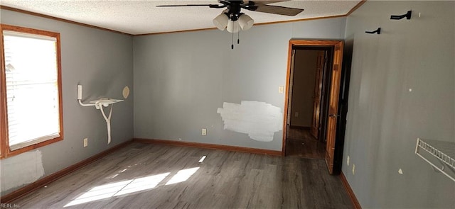 unfurnished room featuring hardwood / wood-style floors, a textured ceiling, ceiling fan, and crown molding