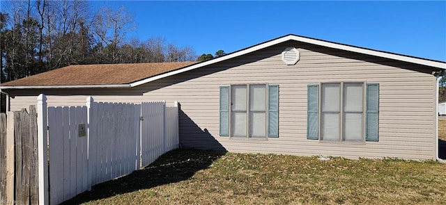 view of side of home with a lawn