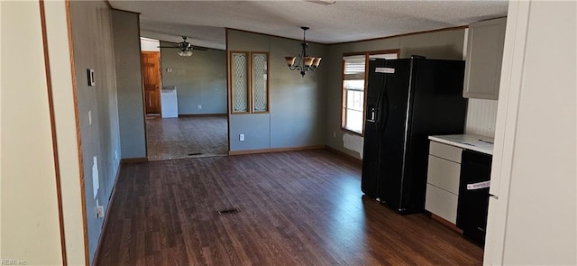 kitchen featuring dark hardwood / wood-style floors, pendant lighting, a textured ceiling, black fridge with ice dispenser, and ceiling fan with notable chandelier