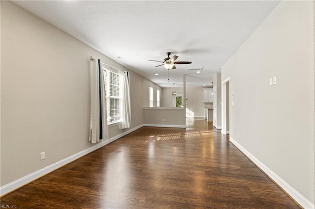 unfurnished living room with ceiling fan and dark hardwood / wood-style floors