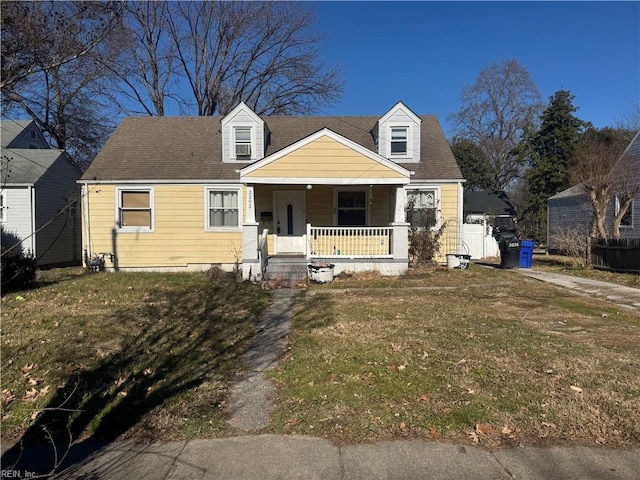 cape cod home with a porch and a front yard