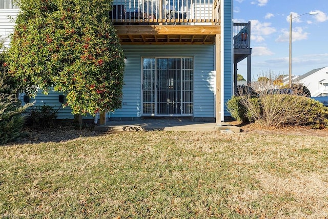 rear view of property featuring a lawn