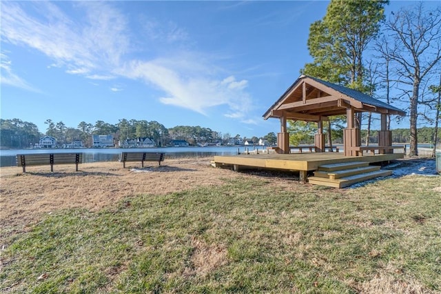 view of property's community featuring a yard and a water view