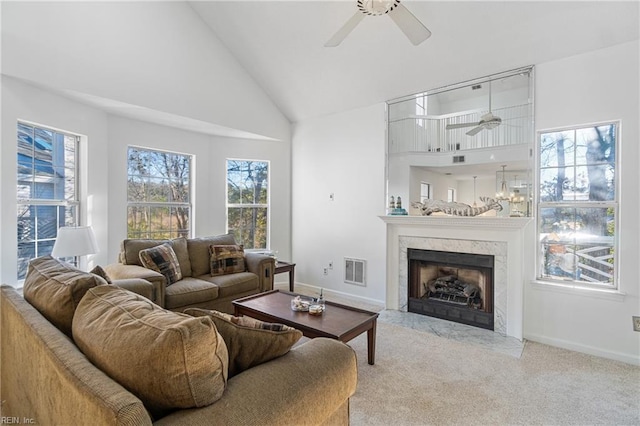 living room with high vaulted ceiling, light carpet, ceiling fan, and a fireplace