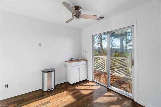 interior space with ceiling fan and dark hardwood / wood-style flooring