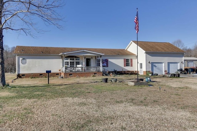 view of front facade featuring a porch, a front lawn, and a garage