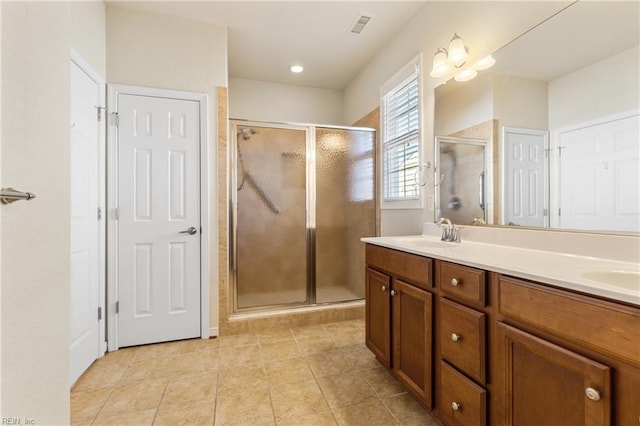 bathroom with vanity and a shower with shower door