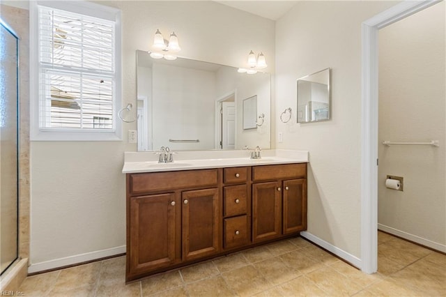 bathroom featuring an enclosed shower, vanity, and a chandelier