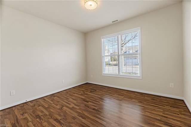 empty room with dark wood-type flooring