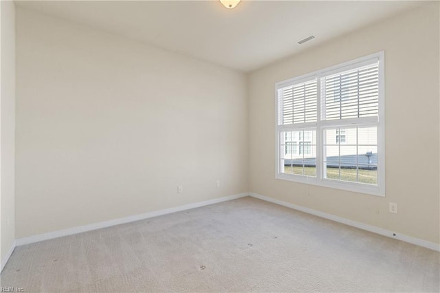 unfurnished room featuring light carpet