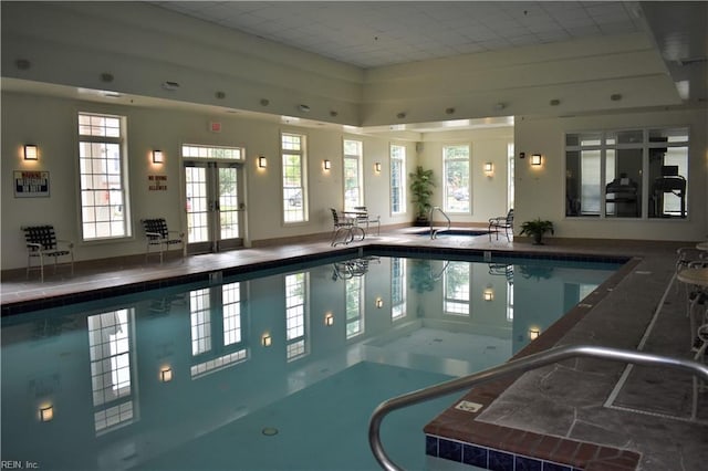 view of swimming pool featuring french doors