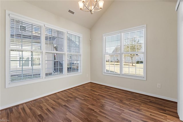 spare room with a notable chandelier, dark wood-type flooring, and lofted ceiling