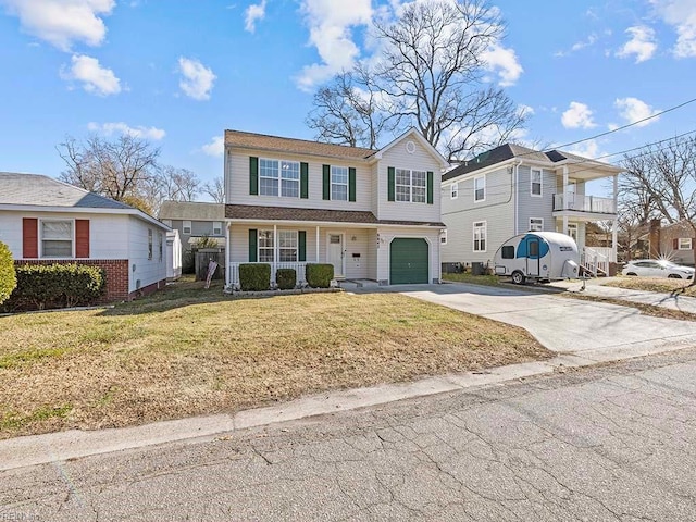 view of front of property featuring a front yard and a garage