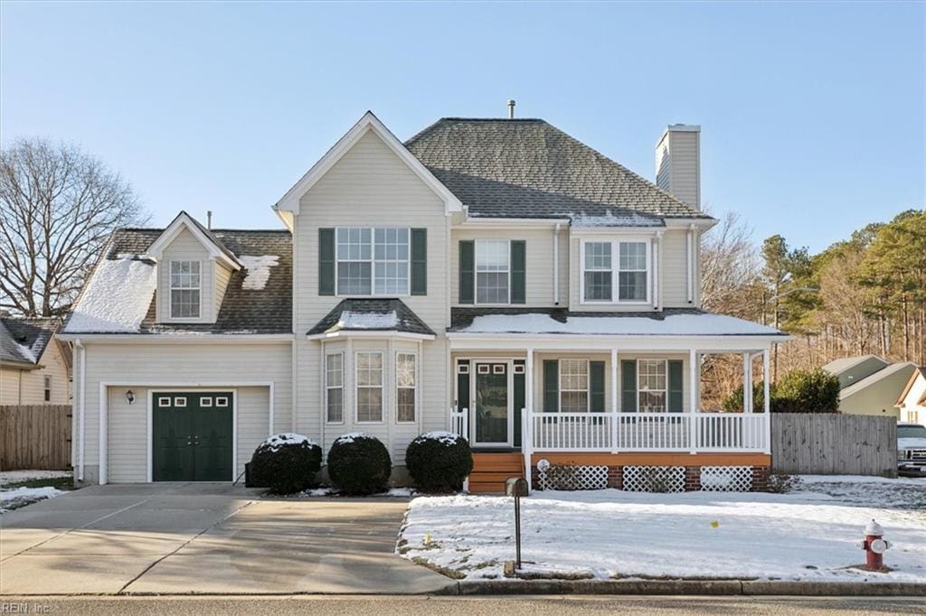 view of front facade featuring a garage and covered porch