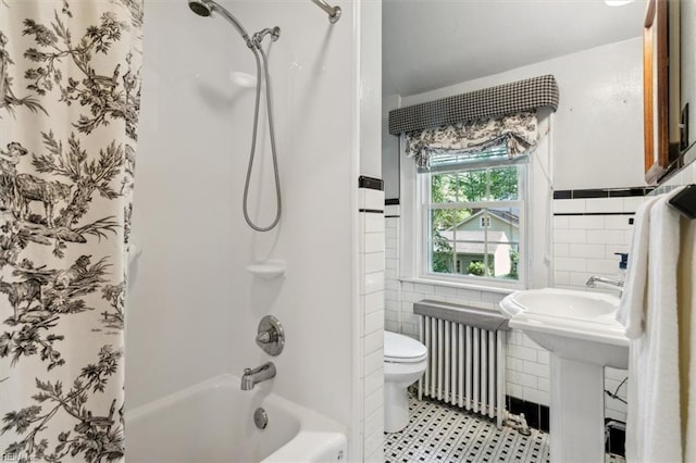 bathroom featuring tile walls, toilet, radiator, and shower / tub combo with curtain