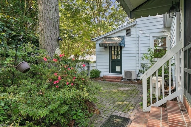 entrance to property featuring ac unit and a patio area