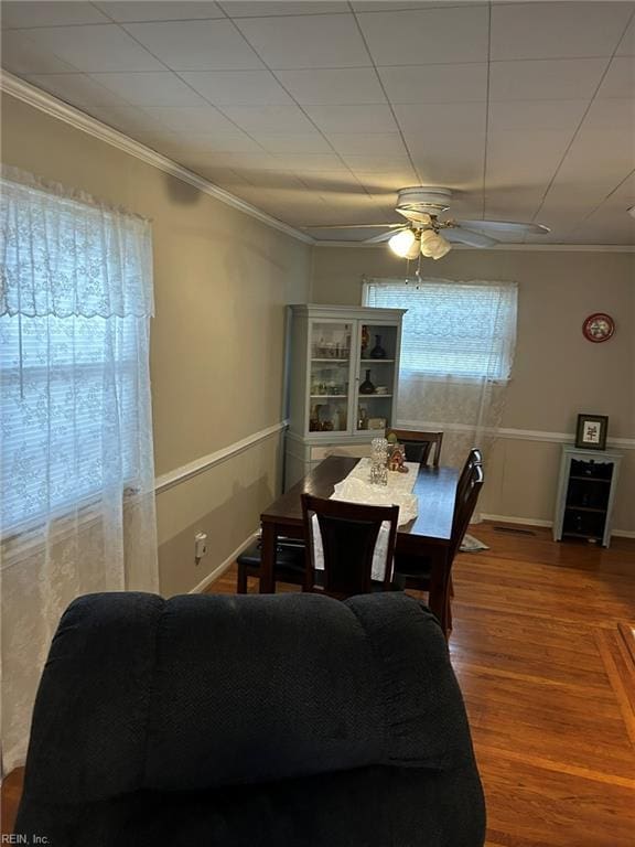 dining area with hardwood / wood-style flooring, ornamental molding, and ceiling fan