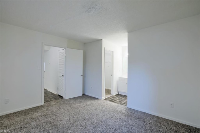 empty room with dark colored carpet