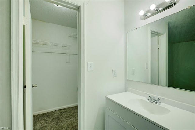 bathroom with a textured ceiling and vanity