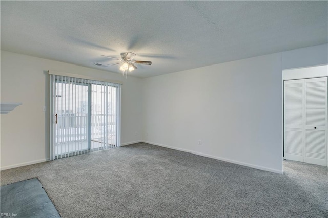 empty room featuring carpet flooring, a textured ceiling, and ceiling fan