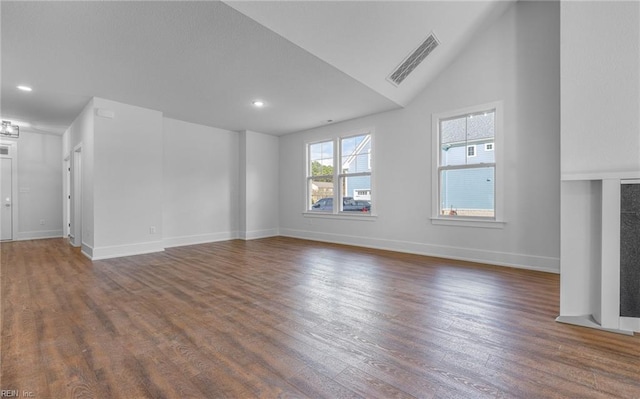 unfurnished living room featuring lofted ceiling and dark hardwood / wood-style floors