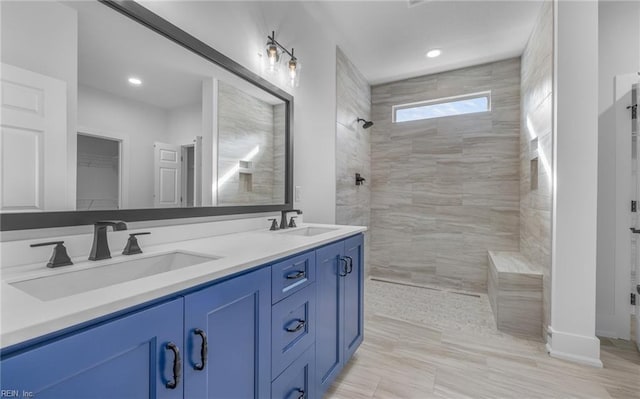 bathroom featuring vanity and tiled shower