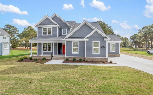 craftsman inspired home featuring a front yard and covered porch