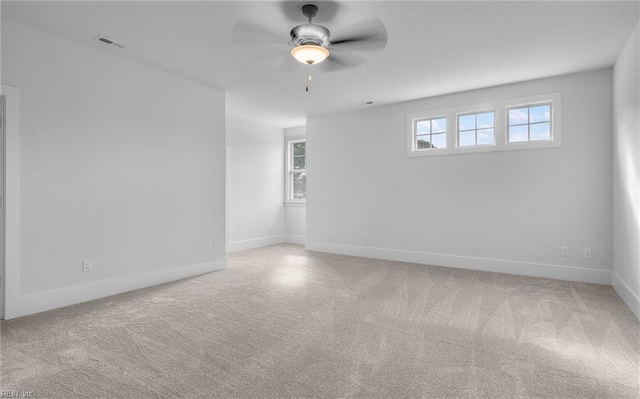 unfurnished room featuring light carpet and ceiling fan